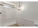 Renovated bathroom with glass-enclosed shower and modern chandelier, creating a spa-like experience at 201 S Greenfield Rd # 152, Mesa, AZ 85206