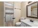 Bathroom featuring a toilet, vanity, mirror, and a doorway view into the laundry area at 201 S Greenfield Rd # 152, Mesa, AZ 85206