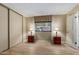 Bright bedroom featuring wood-look floors, a window with blinds, and a spacious closet at 201 S Greenfield Rd # 152, Mesa, AZ 85206
