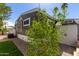 Exterior view with new landscaping featuring paver pathway and vibrant green foliage at 201 S Greenfield Rd # 152, Mesa, AZ 85206
