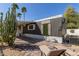 Exterior features updated landscaping and hardscaping, with two lounge chairs to enjoy the day at 201 S Greenfield Rd # 152, Mesa, AZ 85206