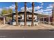 Charming mobile home with a covered carport and well-maintained landscaping, including palm trees at 201 S Greenfield Rd # 152, Mesa, AZ 85206