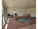 Relaxing indoor community hot tub with seating, steps, and natural light at 201 S Greenfield Rd # 152, Mesa, AZ 85206