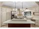 Bright kitchen featuring an island with a built-in cooktop and modern stainless steel appliances at 201 S Greenfield Rd # 152, Mesa, AZ 85206
