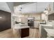 Bright kitchen featuring an island with a built-in cooktop and modern stainless steel appliances at 201 S Greenfield Rd # 152, Mesa, AZ 85206