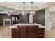 Kitchen island with built-in cooktop and hardwood floors, perfect for Gathering meals at 201 S Greenfield Rd # 152, Mesa, AZ 85206
