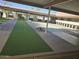 Community shuffleboard space featuring new green turf and concrete perimeter at 201 S Greenfield Rd # 152, Mesa, AZ 85206