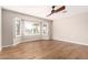 This bedroom features wood floors and a window with plantation shutters at 21417 N 142Nd Dr, Sun City West, AZ 85375