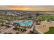 Aerial view of a large community pool, playground, and landscaped common area at 23145 E Stonecrest Dr, Queen Creek, AZ 85142