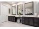 Elegant Primary bathroom featuring dual vanities, framed mirrors, and a makeup station at 23145 E Stonecrest Dr, Queen Creek, AZ 85142