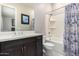 Bathroom featuring dark wood vanity, shower with blue and white curtain, and neutral walls at 23145 E Stonecrest Dr, Queen Creek, AZ 85142