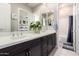 Stylish bathroom features double sinks, large mirrors, and modern fixtures at 23145 E Stonecrest Dr, Queen Creek, AZ 85142