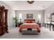 Bright bedroom features plush carpet, decorative ceiling fan, and stylish furniture at 23145 E Stonecrest Dr, Queen Creek, AZ 85142