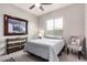 Cozy bedroom features natural light, stylish decor, and contemporary furniture at 23145 E Stonecrest Dr, Queen Creek, AZ 85142