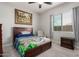 Bedroom with wooden bed frame, chair, nightstand, neutral walls, and ample natural light at 23145 E Stonecrest Dr, Queen Creek, AZ 85142