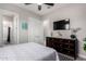Comfortable bedroom with a dresser, mounted TV, and ensuite bathroom access at 23145 E Stonecrest Dr, Queen Creek, AZ 85142