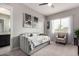 Bright bedroom featuring a daybed, ceiling fan, and neutral decor with a view to the bathroom at 23145 E Stonecrest Dr, Queen Creek, AZ 85142