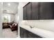 Modern butler's pantry with dark wood cabinets and quartz countertops at 23145 E Stonecrest Dr, Queen Creek, AZ 85142