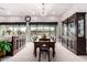 Elegant dining area featuring a large table, dark wood accents, and natural light from sliding glass doors at 23145 E Stonecrest Dr, Queen Creek, AZ 85142