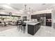 Spacious, open-concept kitchen with stainless steel appliances, large island, and seamless flow to the living area at 23145 E Stonecrest Dr, Queen Creek, AZ 85142