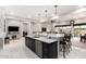 Modern kitchen island with seating, stainless steel appliances, and sleek cabinetry creates a stylish and functional space at 23145 E Stonecrest Dr, Queen Creek, AZ 85142