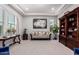 Elegant living room with coffered ceiling, hardwood bookcase, and view of manicured lawn at 23145 E Stonecrest Dr, Queen Creek, AZ 85142