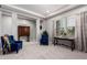 Bright living room featuring dark blue chairs, tile flooring, and coffered ceilings at 23145 E Stonecrest Dr, Queen Creek, AZ 85142