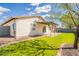Exterior shot of the backyard, showing the patio, lawn, and a glimpse of the home's architecture at 2317 E Concorda Dr, Tempe, AZ 85282