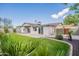 Backyard with landscaped lawn, covered patio, and block wall at 2317 E Concorda Dr, Tempe, AZ 85282