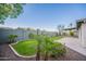 Backyard features a landscaped lawn, gravel bed, and block wall at 2317 E Concorda Dr, Tempe, AZ 85282