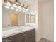Bathroom featuring a large mirror, vanity lights, quartz countertop, and a new cabinet at 2317 E Concorda Dr, Tempe, AZ 85282