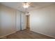 This is a bright bedroom with a closet, and a ceiling fan at 2317 E Concorda Dr, Tempe, AZ 85282