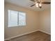 Bedroom featuring a ceiling fan and large window at 2317 E Concorda Dr, Tempe, AZ 85282