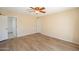 Bedroom featuring wood floors, a ceiling fan, and an attached bathroom at 2317 E Concorda Dr, Tempe, AZ 85282