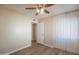 Bright bedroom features light-colored walls, wood floors, ceiling fan, and closet at 2317 E Concorda Dr, Tempe, AZ 85282