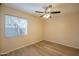 This bedroom is spacious and bright, featuring new floors and large window at 2317 E Concorda Dr, Tempe, AZ 85282