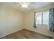 Cozy bedroom with a new floor and lots of natural light from the large window at 2317 E Concorda Dr, Tempe, AZ 85282