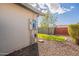Side view of the house with an electrical panel and a small tree adding a touch of greenery to the gravel landscape at 2317 E Concorda Dr, Tempe, AZ 85282