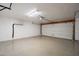 Clean and spacious garage with white walls and a roll-up door at 2317 E Concorda Dr, Tempe, AZ 85282