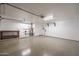 Clean and spacious garage with white walls and a roll-up door at 2317 E Concorda Dr, Tempe, AZ 85282