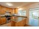 Bright kitchen features wood cabinets, stainless steel appliances, and views of the patio at 2317 E Concorda Dr, Tempe, AZ 85282