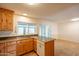 Spacious kitchen offers tile floors, wood cabinets, and a large sink with natural light at 2317 E Concorda Dr, Tempe, AZ 85282