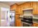 View of kitchen features stainless steel appliances and wood cabinetry at 2317 E Concorda Dr, Tempe, AZ 85282