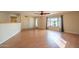 Well-lit living room with wood-look flooring, ceiling fan and doorway to the backyard at 2317 E Concorda Dr, Tempe, AZ 85282