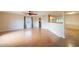 Spacious living room featuring wood-look flooring, a ceiling fan, and a large window with curtains at 2317 E Concorda Dr, Tempe, AZ 85282