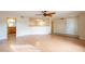 Open concept living room with wood-look flooring, ceiling fan and view into the kitchen at 2317 E Concorda Dr, Tempe, AZ 85282