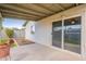 Covered patio with sliding glass doors and landscaped yard at 2317 E Concorda Dr, Tempe, AZ 85282