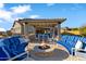 Outdoor fire pit area with stylish seating, covered dining, and a cozy atmosphere for relaxing and entertaining at 2317 N Steele Cir, Mesa, AZ 85207