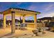 An outdoor dining area with a gazebo and outdoor kitchen with a BBQ area for parties and entertaining at 2317 N Steele Cir, Mesa, AZ 85207