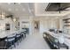 Modern kitchen with barstool seating at the large island and a view of dining and living areas at 2317 N Steele Cir, Mesa, AZ 85207